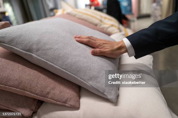 human hand touching pillow - pillow foto e immagini stock