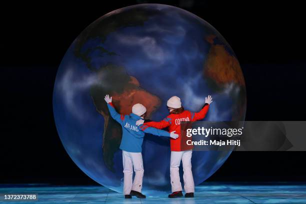 Children representing Milan and Cortina hug a globe as part of the handover ceremony during the Beijing 2022 Winter Olympics Closing Ceremony on Day...