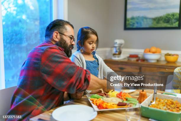 family eating together at holiday table - indian family dinner table stock pictures, royalty-free photos & images