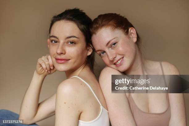 portrait of beautiful female friends standing together - couple portrait soft ストックフォトと画像