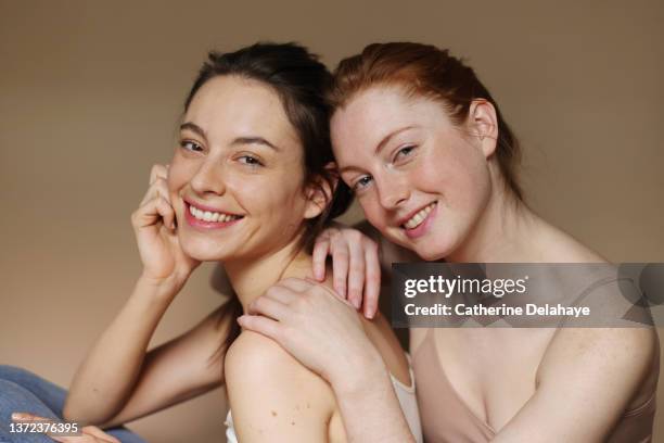 portrait of beautiful female friends standing together - couple portrait soft ストックフォトと画像