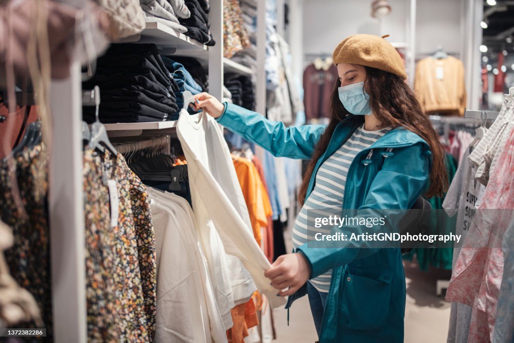 Pregnant woman shopping for maternity clothes.