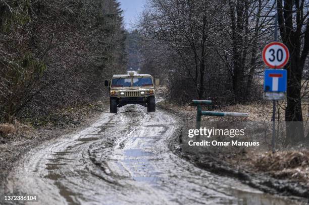 An U.S. Army Humvee assigned to the 82nd Airborne Division exits an operating base at the Arlamow Airport on February 23, 2022 in Wola Korzeniecka,...
