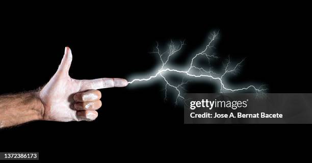 hand of a man simulating an electrical shot with lightning. - forked lightning stock pictures, royalty-free photos & images