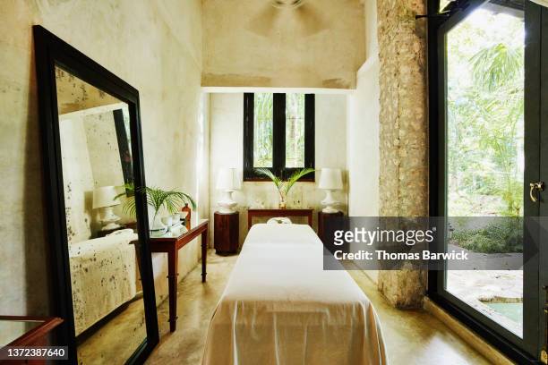 wide shot of massage table in luxury spa - massage table stock pictures, royalty-free photos & images