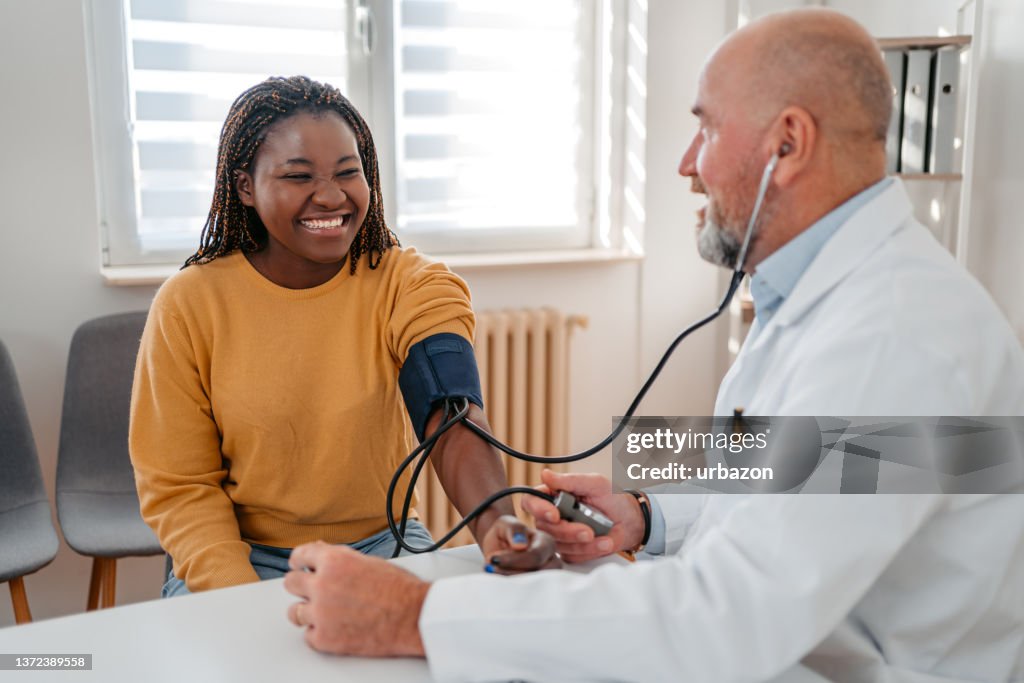 Doctor Measuring Blood Pressure Of The Patient
