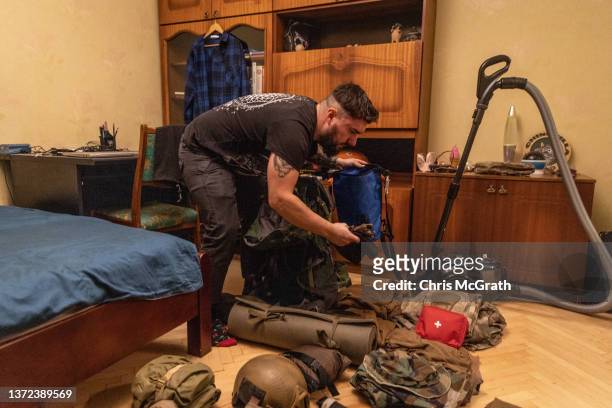 Reservist, 28 year-old Anton Lytvyn packs his military equipment at his house after he was called up to active duty on February 23, 2022 in Kyiv,...