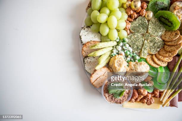 fresh charcuterie board for st. patrick's day - angela auclair stock pictures, royalty-free photos & images