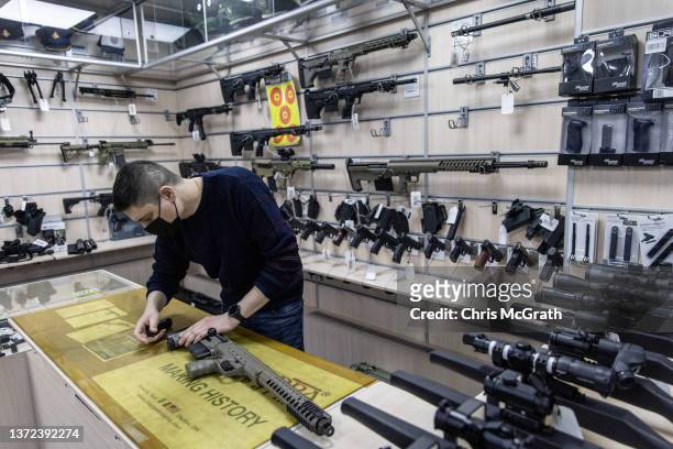 An employee works at the gun counter of a tactical equipment shop on February 23, 2022 in Kyiv, Ukraine. Ukrainian President Volodymyr Zelensky...