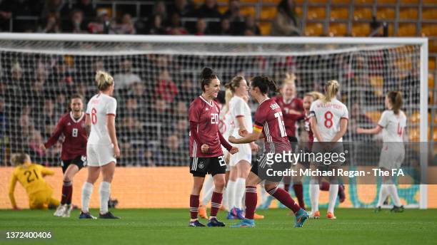 Lina Magull of Germany celebrates with teammate Sara Dabritz after scoring their team's first goal during the Arnold Clark Cup match between England...