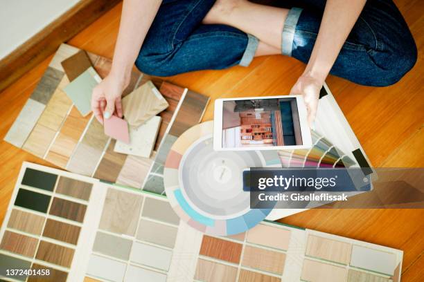 female interior designer using a tablet while looking over swatches at work - paint strip stock pictures, royalty-free photos & images