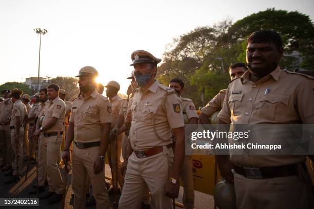 Police personnel patrol during a demonstration held by various Hindu organizations against the killing of Harsha, a member of a Hindu group, on...