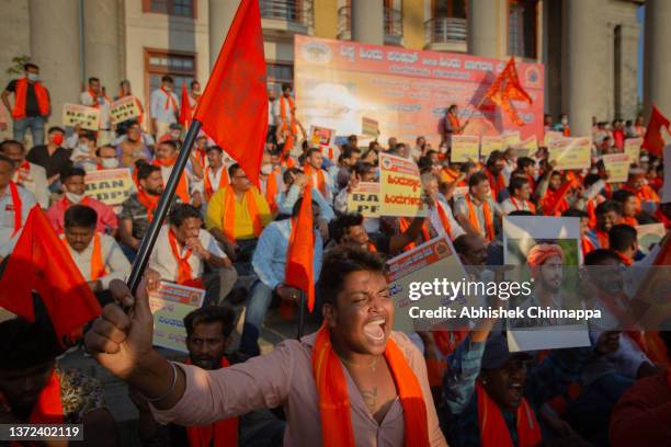 Protestors affiliated with various Hindu organizations wave placards and shout slogans during a demonstration against the killing of Harsha, a member...