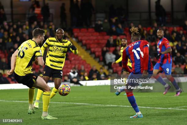 Wilfried Zaha of Crystal Palace scores their team's fourth goal during the Premier League match between Watford and Crystal Palace at Vicarage Road...