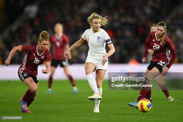 Leah Williamson of England passes the ball under pressure from Linda Dallmann and Jule Brand of Germany during the Arnold Clark Cup match between...