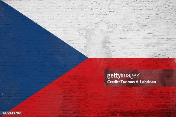 full frame photo of a weathered flag of czech republic painted on a plastered brick wall. - czech republic flag stock pictures, royalty-free photos & images