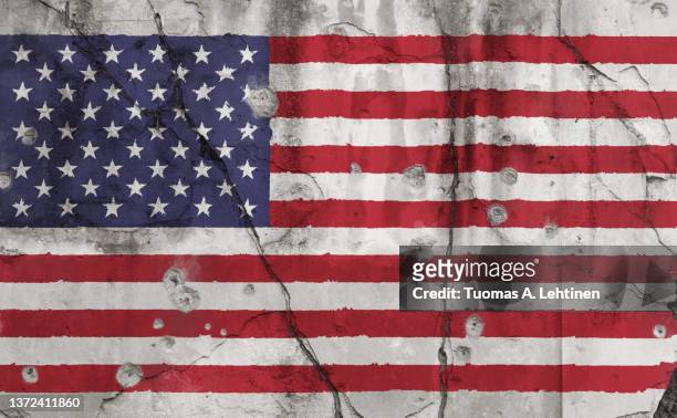 full frame photo of a weathered flag of united states (usa, us, america) painted on a cracked wall with bullet holes. - kulhål bildbanksfoton och bilder