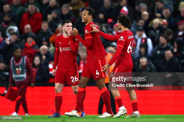Virgil van Dijk of Liverpool celebrates with teammates Andrew Robertson and Trent Alexander-Arnold after scoring their team's sixth goal during the...