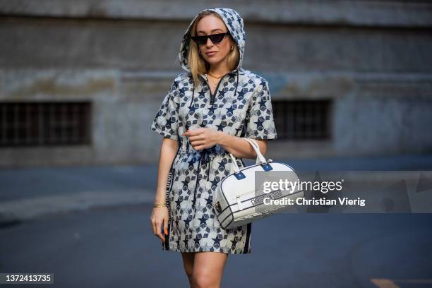 Sonia Lyson is seen wearing neon green knee high boots Bettina Vermillion X Emili Sindlev, Dior weekender bag, Dior hooded coat with print,...