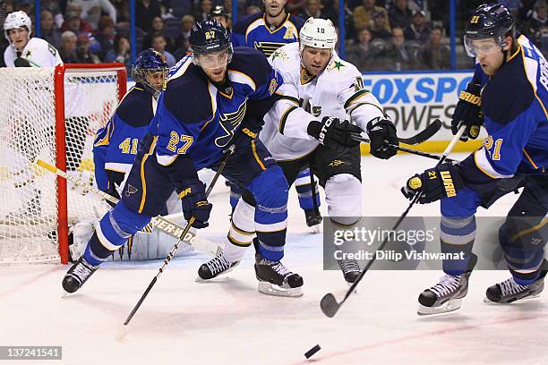 Alex Pietrangelo and Patrik Berglund both of the St. Louis Blues look to beat Brenden Morrow of the Dallas Stars to the puck at the Scottrade Center...