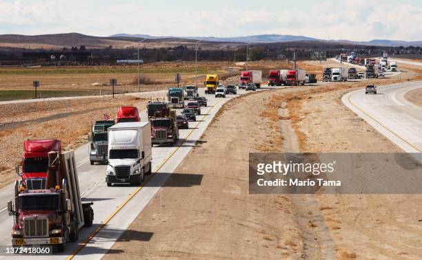 The ‘People’s Convoy’ of truckers and supporters drives on its way to Washington, DC to protest COVID-19 mandates on February 23, 2022 near Barstow,...