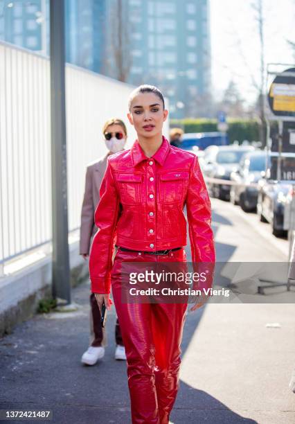 British actress Amy Jackson is seen wearing red jacket, vinyl pants, ankle boots outside Diesel fashion show during the Milan Fashion Week...