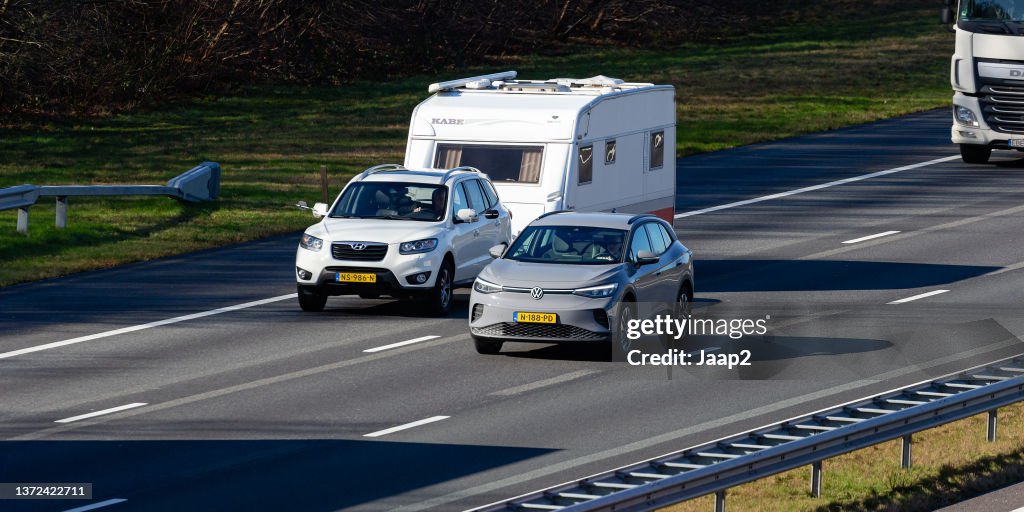 Dutch Hyundai Santa Fe with caravan + electric VW ID.4 on the A1 highway