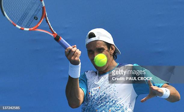 Juan Ignacio Chela of Argentina plays a stroke during his men's singles match against Michael Russell of the US on the second day of the Australian...