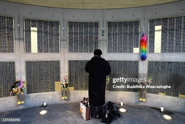 Man prays for the victims of the Kobe Great Earthquake during a memorial ceremony to commemorate the 17th anniversary of the 1995 Great Hanshin...
