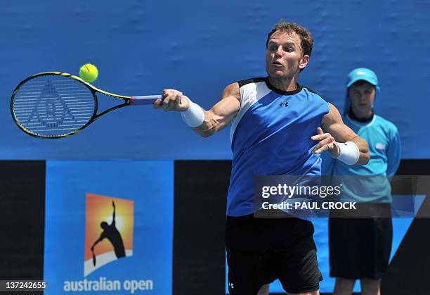 Michael Russell of the US plays a stroke during his men's singles match against Juan Ignacio Chela of Argentina on the second day of the Australian...