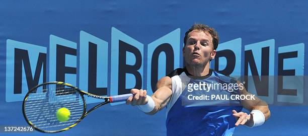 Michael Russell of the US plays a stroke during his men's singles match against Juan Ignacio Chela of Argentina on the second day of the Australian...