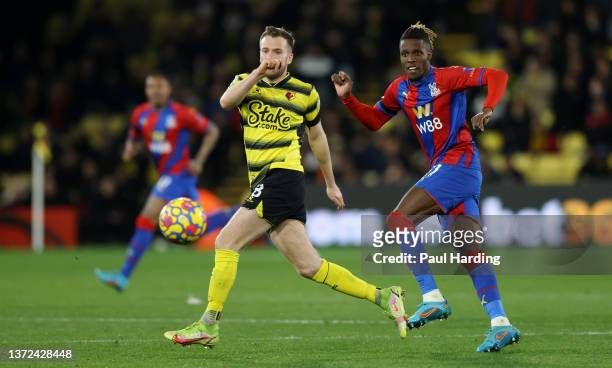 Wilfried Zaha of Crystal Palace is put under pressure by Tom Cleverley of Watford FC during the Premier League match between Watford and Crystal...