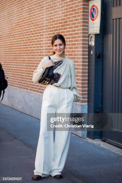 Gala Gonzalez seen wearing white wide leg pants, top, black bag, shoes outside of Fendi fashion show during the Milan Fashion Week Fall/Winter...