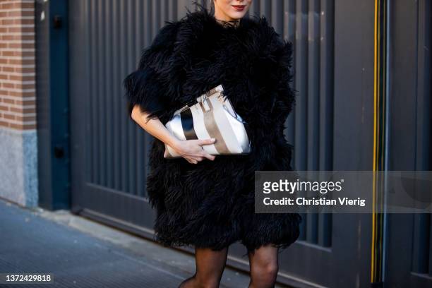 Mary Leest seen wearing black fur coat, striped Fendi bag, sheer tights, sunglasses, heels outside of Fendi fashion show during the Milan Fashion...
