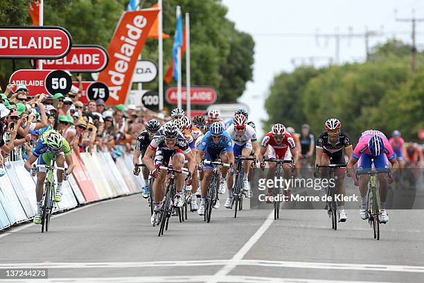 Andre Greipel of Germany and team Lotto-Belisol finishes the race first in a photo finish with Alessandro Petacchi of Italy and team Lampre-ISD...