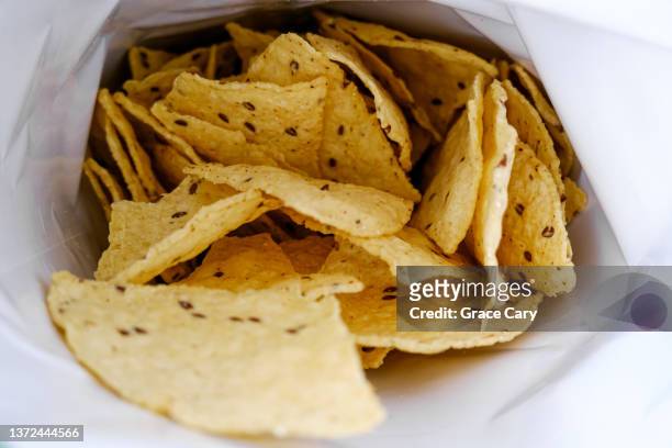 open bag of multigrain tortilla chips - chips bag stockfoto's en -beelden