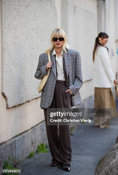 Eleonora Carisi seen wearing grey oversized checkered blazer, brown pants, beige bag outside of Alberta Ferretti fashion show during the Milan...