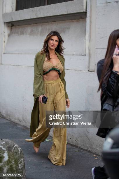 Italian actress Elisabetta Canalis seen wearing cropped top, green coat, beige pants outside of Alberta Ferretti fashion show during the Milan...