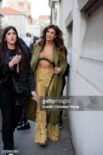Italian actress Elisabetta Canalis seen wearing cropped top, green coat, beige pants outside of Alberta Ferretti fashion show during the Milan...