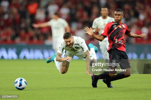 Rafael of Palmeiras falls down as he fights for the ball with Erick of Athletico Paranaense during a match between Athletico Paranaense and Palmeiras...