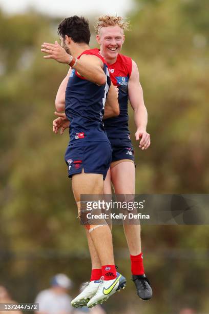 Clayton Oliver of the Demons and Christian Petracca of the Demons celebrate during the AFL practice match between the Melbourne Demons and the North...