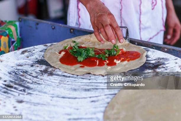 a woman preparing quesadillas, tortillas with cheese in mexico - oaxaca stock pictures, royalty-free photos & images