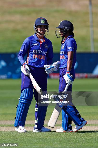 Indian player Smriti Mandhana celebrates her half century with teammate Harmanprett Kaur during game five in the One Day International series between...