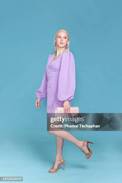 stylish woman in purple dress - purple dress stock pictures, royalty-free photos & images