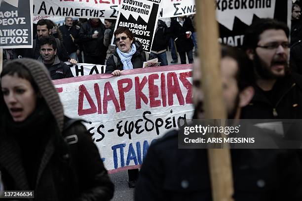 Demonstrators shout slogans during a 24-hour strike against the austerity measures in Athens on January 17, 2012. Greece's main union called for a...