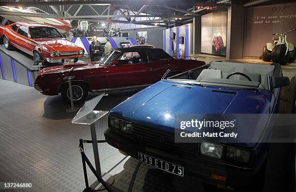 People look at cars, including a roofless Renault 11 TXE that was used in the 1985 James Bond film A View To a Kill, currently displayed at the Bond...