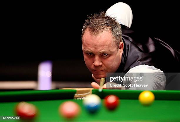 John Higgins in action during his match with Matthew Stevens during day three of the The Masters at Alexandra Palace on January 17, 2012 in London,...