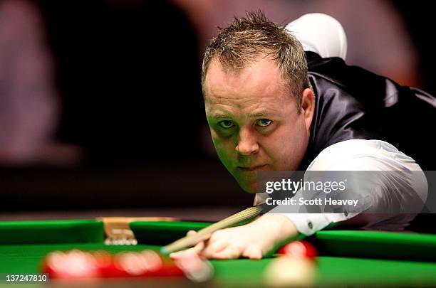 John Higgins in action during his match with Matthew Stevens during day three of the The Masters at Alexandra Palace on January 17, 2012 in London,...