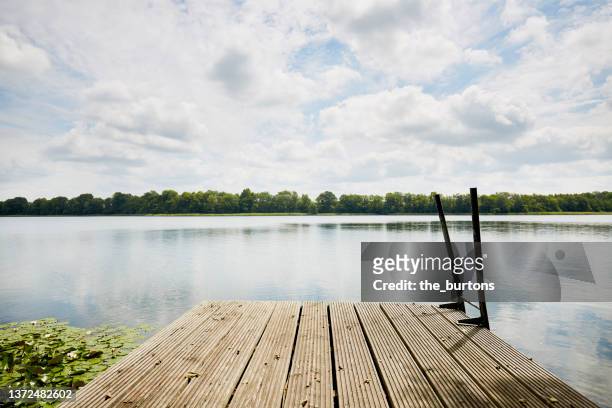 jetty at an idyllic lake - lake shore stock pictures, royalty-free photos & images