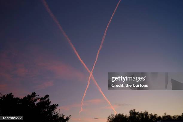 low angle view of vapor trails during sunset - nature alphabet letters bildbanksfoton och bilder